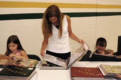 Sunday Party at OLS School
Photo Albums: Julia, Cathy, and Thomas Higham check the pictures.
