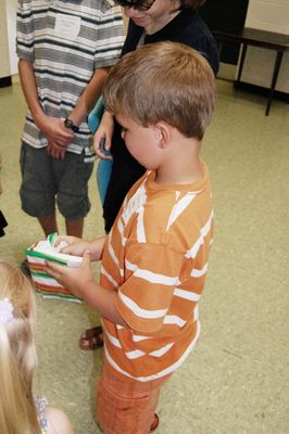 Sunday Party at OLS School
Games: Jeffrey Yuelling opens his gift.
