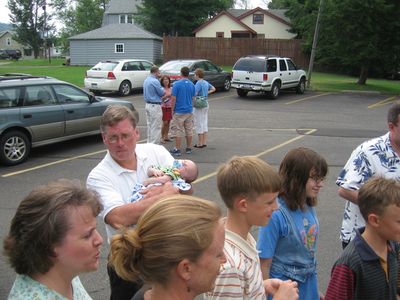 Saturday Church 3
Church 3:  Family members watch Jan open gift.
