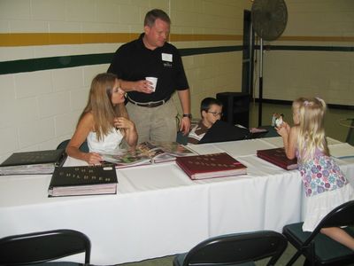 Sunday Party at OLS School
Photos: Cathy, John, Thomas, and Julia Higham look at family photos.
