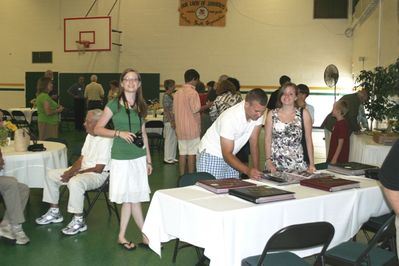 Sunday Party at OLS School
Photo albums: Rachel looks on as Andy Foley and Katie Higham view albums.
